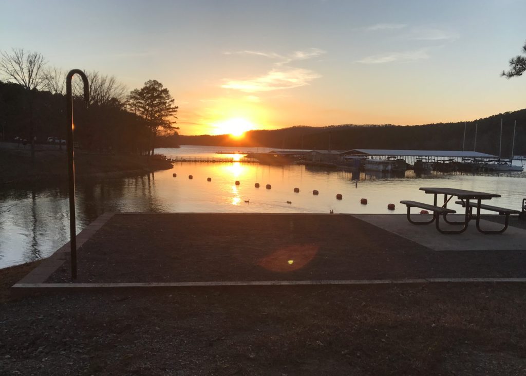 the sun setting over the marina at Lake Ouachita State Park