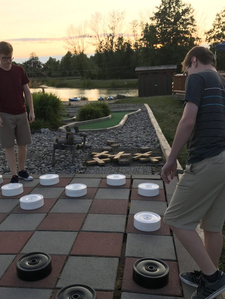 children playing giant checkers at Branches of Niagara campground