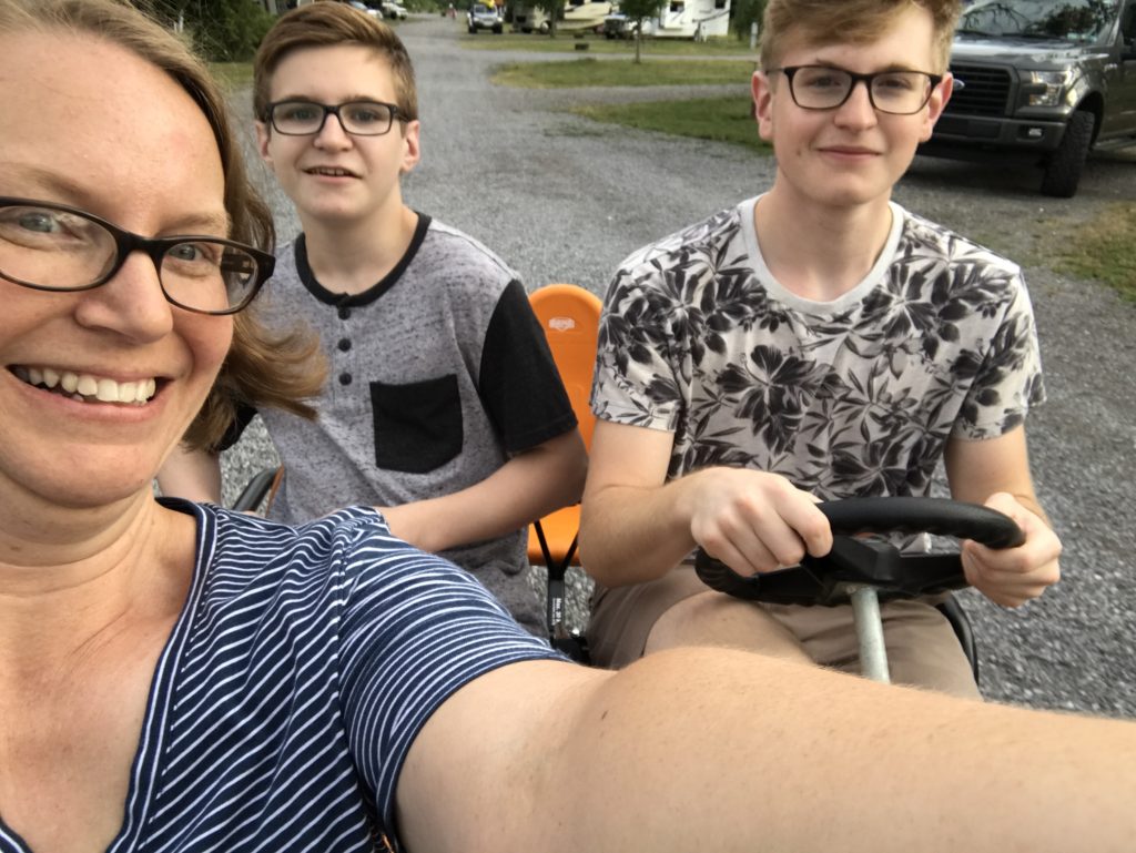 our family riding in a peddle bike at Branches of Niagara campground