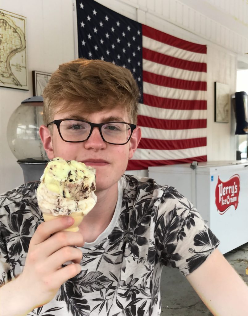 a teenage boy eating an ice cream cone at Adrian's Custard and Beef in Grand Island, NY