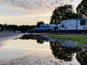 Truck and RV reflected in a pond